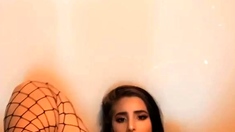 Brunette seductress working her big boobs and hot ass