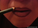 Naughty cutie puts some lip gloss on her sensual and thick lips